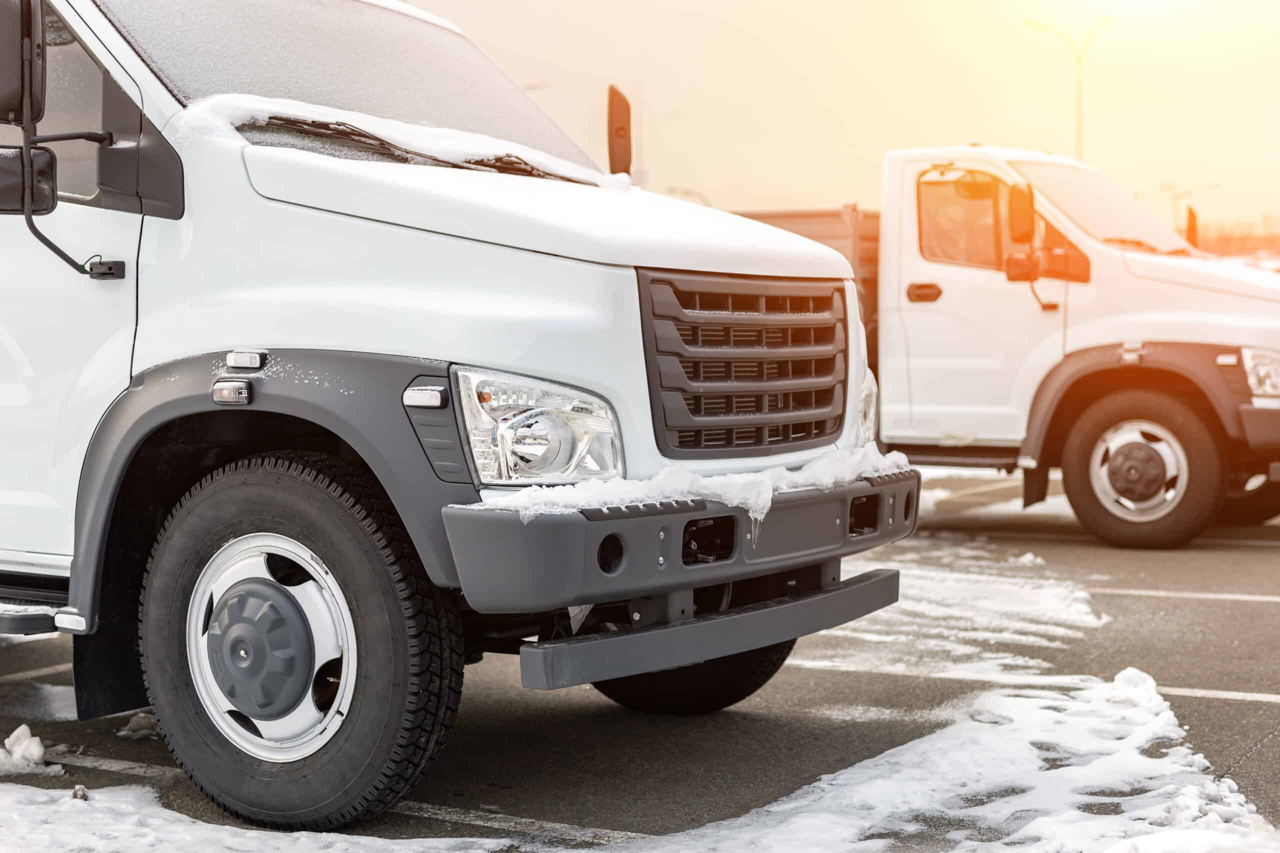New middle size trucks at dealership parking outdoors at winter. Truck service and maintenance. Delivering and warehouse service